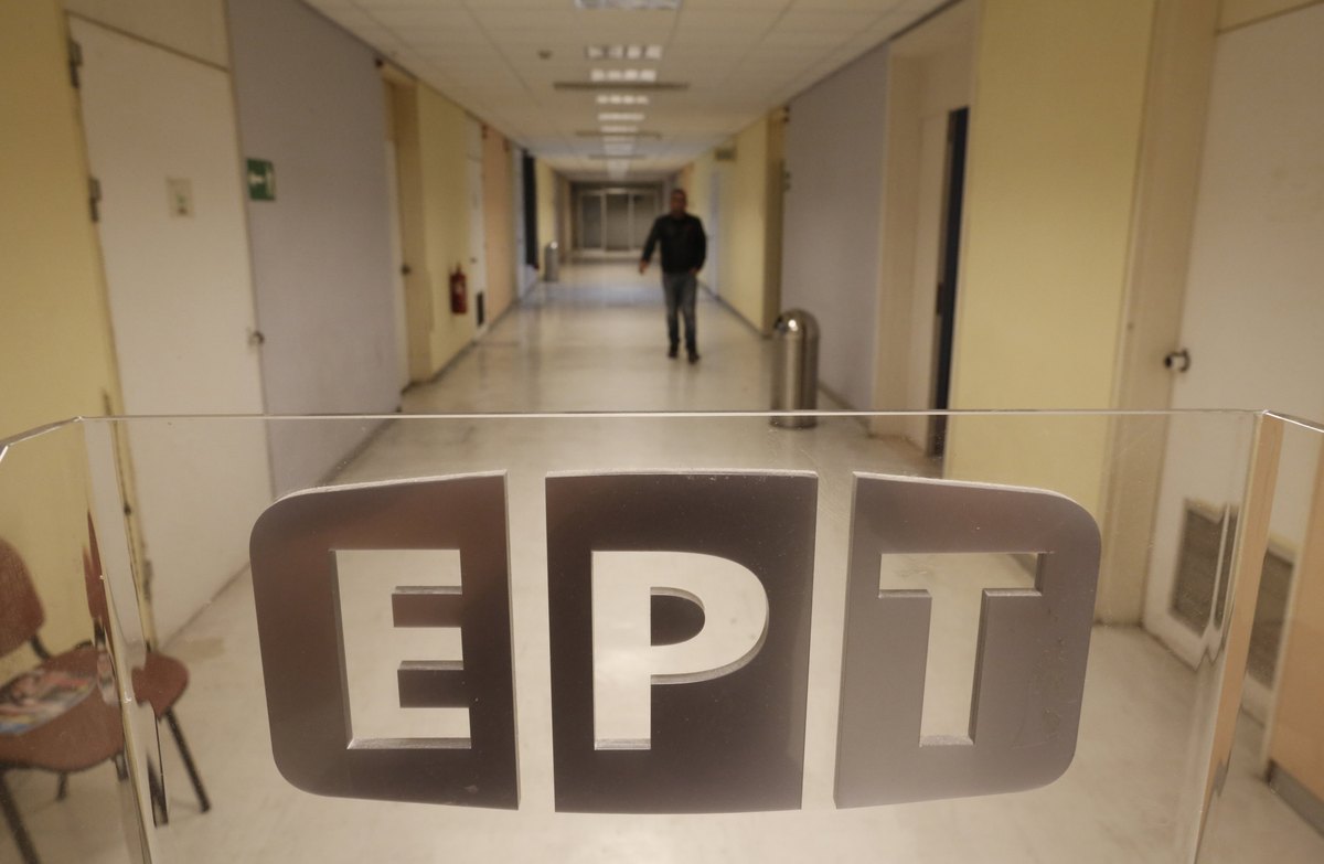 An employee walks in a hall inside greek state television ert headquarters in athens