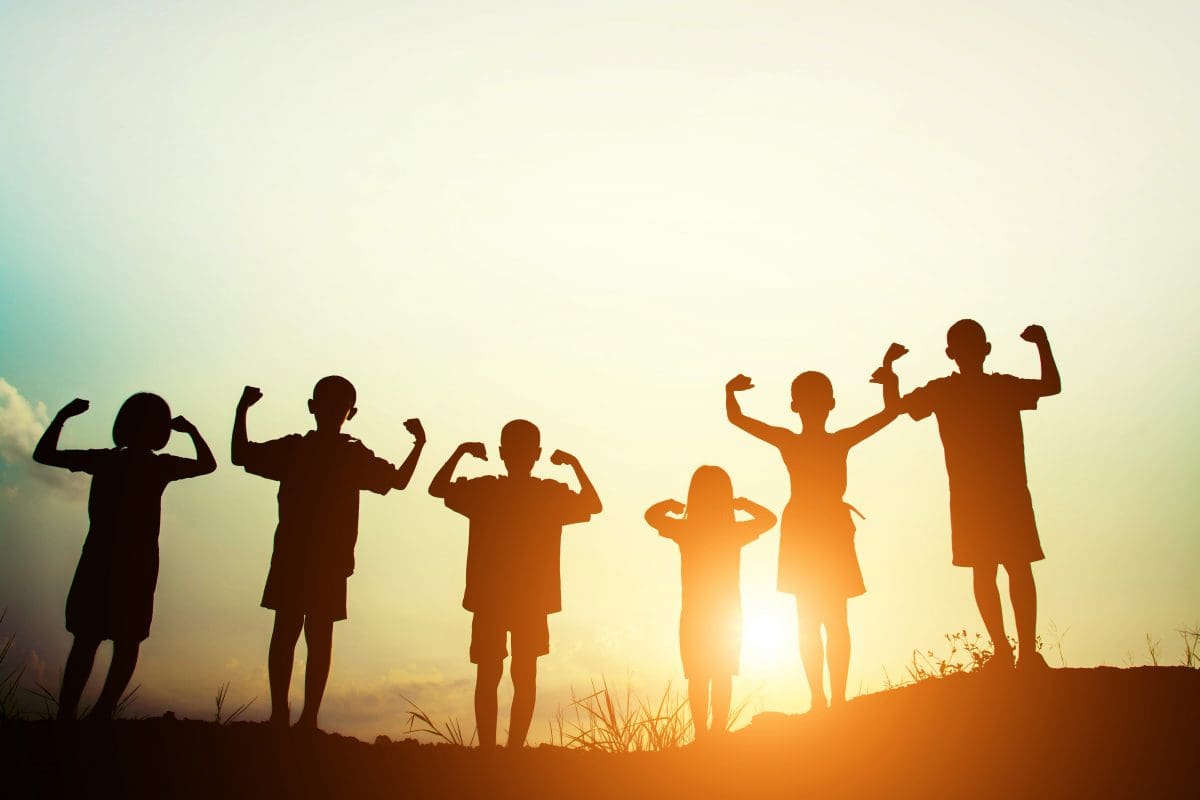 Children s silhouettes showing muscles sunset 1200x800